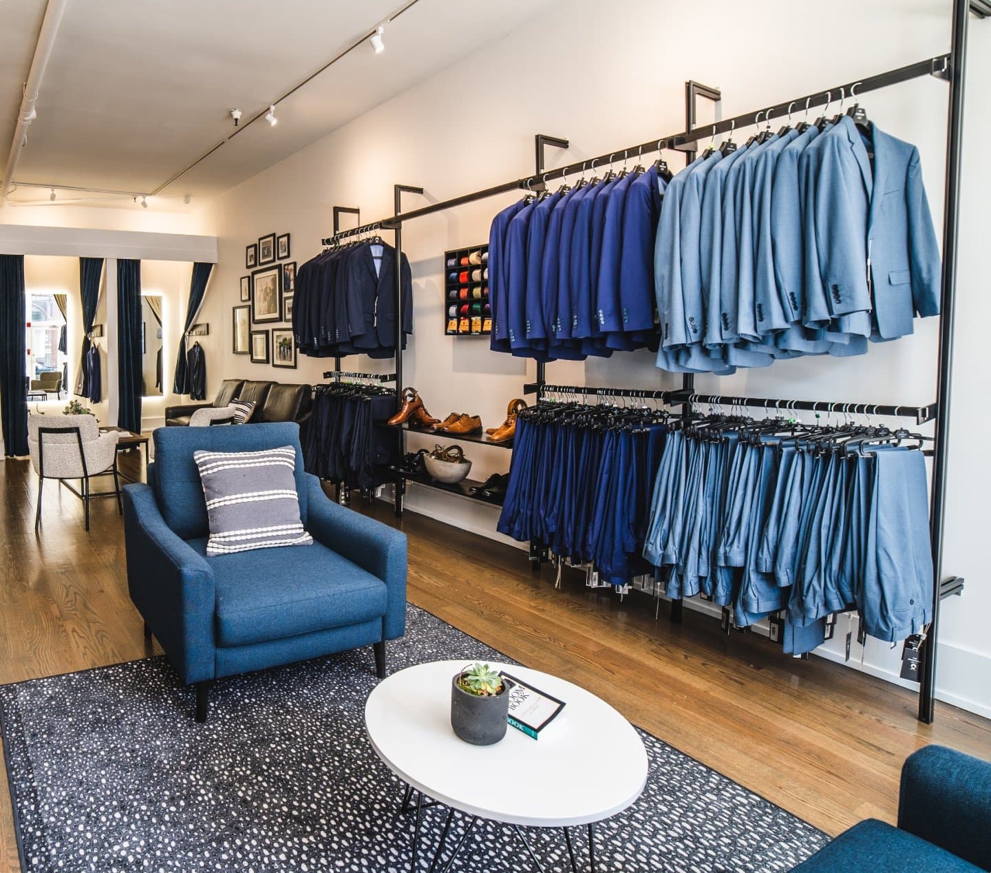 A collection of blue wedding suits in a suit showroom